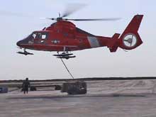 Vertical Replenishment (VERTREP) entails flying cargo nets full of equipment suspended below the helicopter.