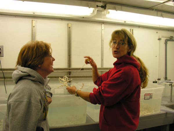 Teacher Tracy Griffin discusses the health of the Lophelia coral being kept in the onboard 'cold room' with Principal Investigator Dr. Sandra Brooke.