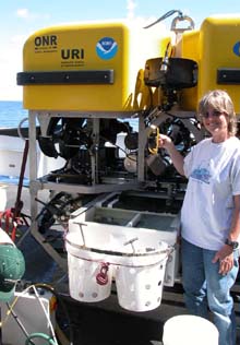 Susan Mills of the Woods Hole Oceanographic Institution retrieves a settlement block from the ROV Hercules.