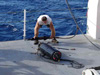 LLS survey team member John Stange examines the tow sled control body after retrieval.