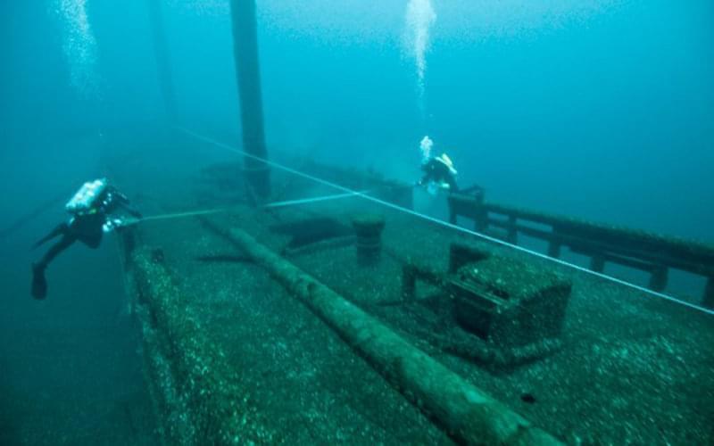 Archaeologists from  the Thunder Bay National Marine Sanctuary — with support from the Cooperative Institute for Ocean Exploration, Research and Technology — document the wreck of the schooner Defiance, which rests in 56 meters (185 feet) of water just north of the sanctuary. In order to capture the wreck's current state of preservation, the team produced hand-drawn maps and photomosaics. This type of archeological investigation is an important follow up to discovering new shipwreck sites.