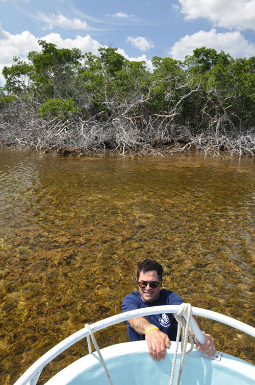 Arriving at Vista Alegre at low tide, Dominique Rissolo tugs the overloaded lancha through the shallow waters of the lagoon.