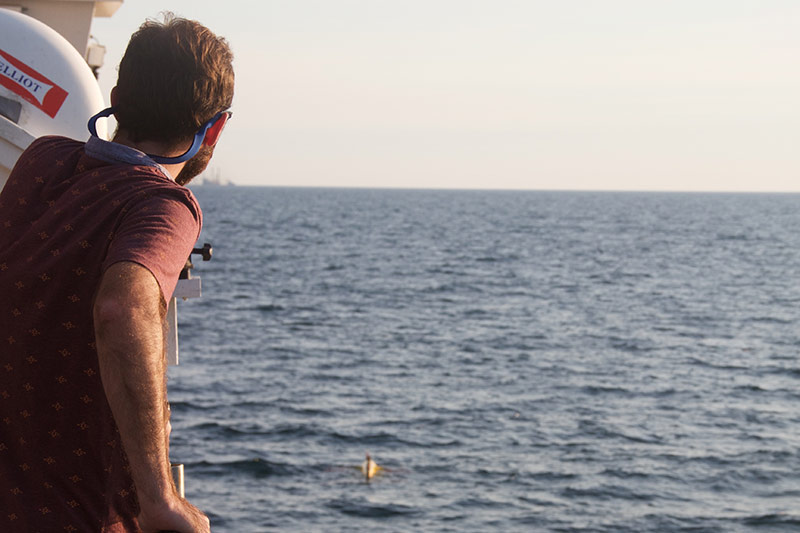 Shelby Bowden, multibeam processor, watches the Sentry practice deployment from NOAA Ship Pisces.