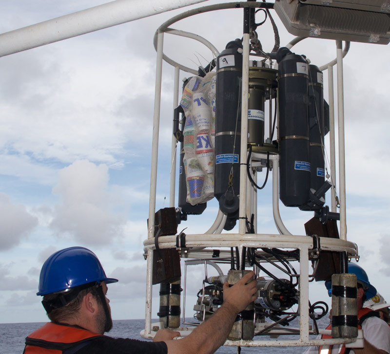 The mesh bag of cups is secured to the CTD rosette before being deployed to the deep sea.