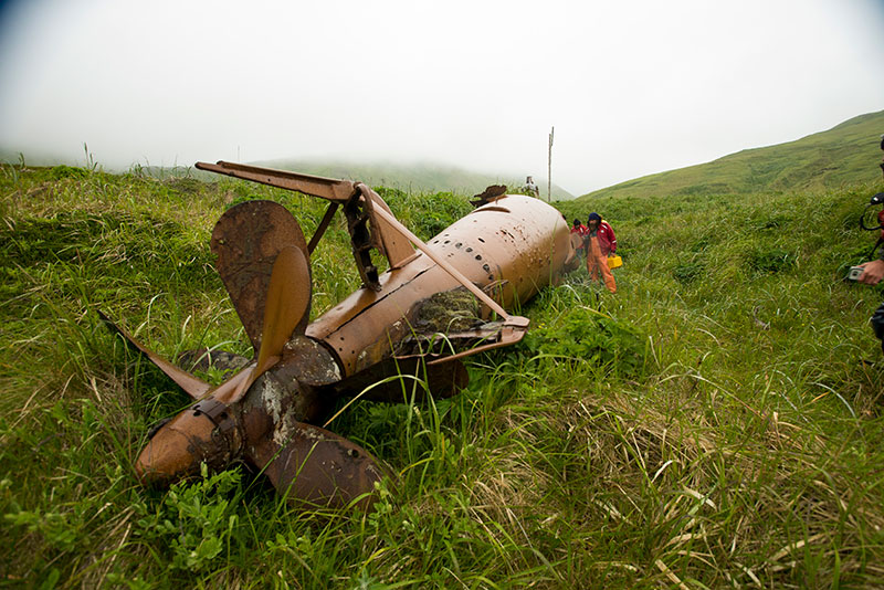 Members of the expedition take time to examine a Japanese mini submarine that remains in the historic sub pens on Kiska Island.