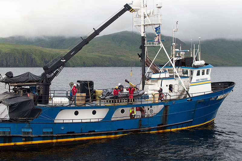 Team members launch one of the project’s four REMUS 100 autonomous underwater vehicles from research vessel Norseman II for a survey of the seafloor.