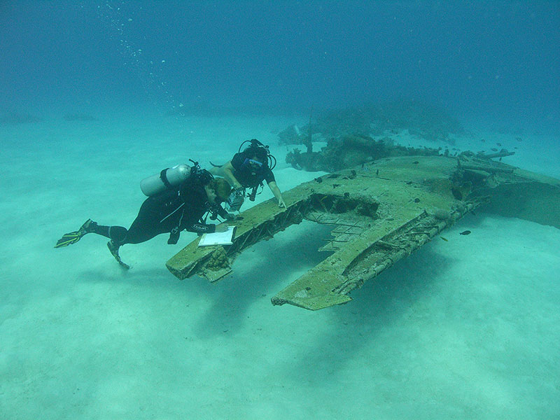 Archaeologists using pencil and Mylar to record World War II sites in Saipan.