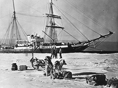 USS Bear moored to the ice shelf at West Base, Antarctica, in January 1941 showing the vessel's pre-World War II configuration.