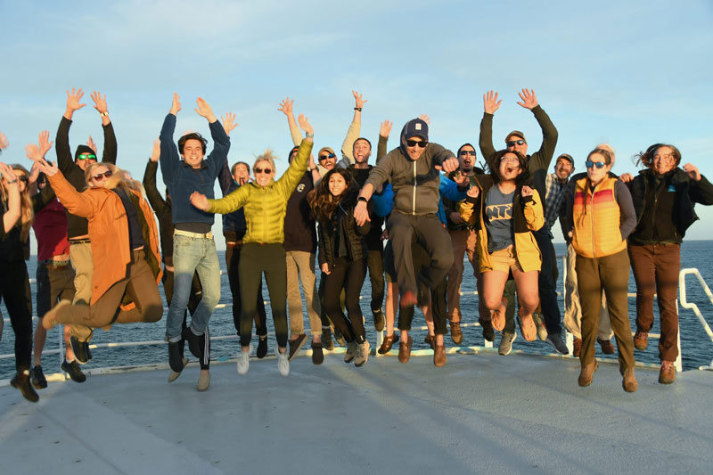 The Student Explorations Around Southern California: Acoustics, Paleolandscapes, and Environments at Sea (SEASCAPES) project science team and members of the Research Vessel Sally Ride crew jumping for joy over the fact that they were able to accomplish project goals despite weather setbacks!