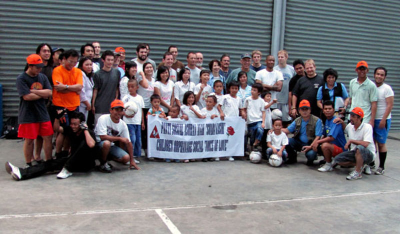 Crew from NOAA Ship Okeanos Explorer and Indonesian Research Vessel Baruna Jaya IV pose with children and staff from a local orphanage.