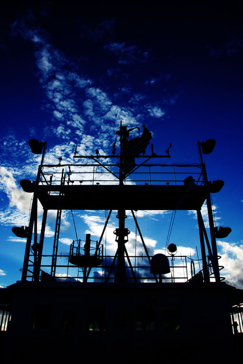 Silhouetted image of the NOAA Ship Okeanos Explorer bridge.