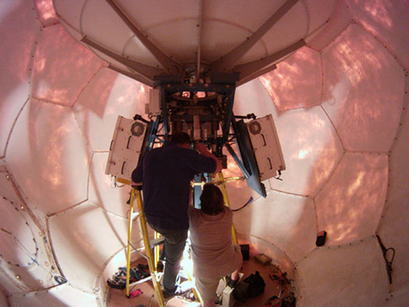 Technicians work to repair the satellite antenna in the VSAT dome.