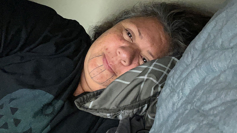 Mia Lopez rests in her bunk during the 2023 EXPRESS: Exploration of Central California Coast expedition on NOAA Ship Okeanos Explorer.