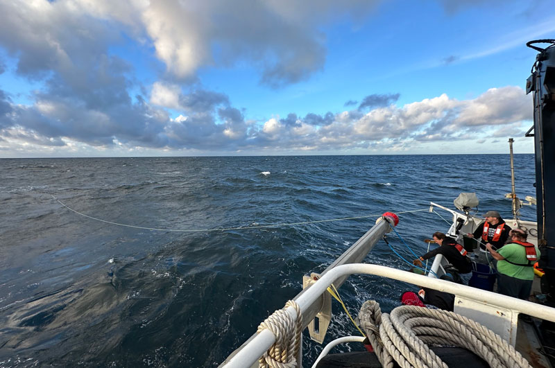 A crab pot puller, mounted to the side of NOAA Ship Okeanos Explorer, feeds out the line attached to one of the deployment configurations of the Maka Niu system.